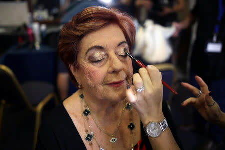 Holocaust survivor Madeleine Schwartz, 74, gets make up before the beginning of the annual Holocaust survivors' beauty pageant in Haifa, Israel October 14, 2018. REUTERS/Corinna Kern