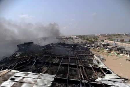 Smoke rises from a milk factory hit by an air strike in Yemen's western port city of Houdieda April 1, 2015. REUTERS/Stringer