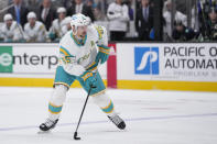 San Jose Sharks defenseman Erik Karlsson prepares to shoot against the Vancouver Canucks during the first period of an NHL hockey game in San Jose, Calif., Wednesday, Dec. 7, 2022. (AP Photo/Godofredo A. Vásquez)