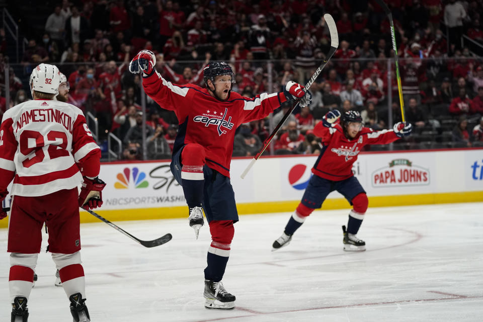 Washington Capitals center Evgeny Kuznetsov, center, celebrates his goal in the second period of an NHL hockey game against the Detroit Red Wings, Wednesday, Oct. 27, 2021, in Washington. (AP Photo/Alex Brandon)