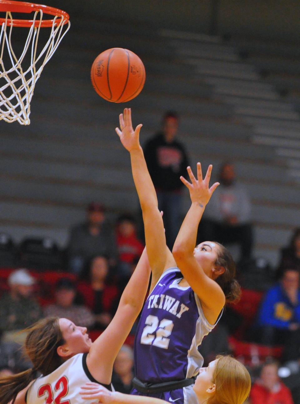 Triway's Leah Wirth puts up a short jump shot in the lane against Columbiana's Lilly Hoschar and Ellie Venezia.