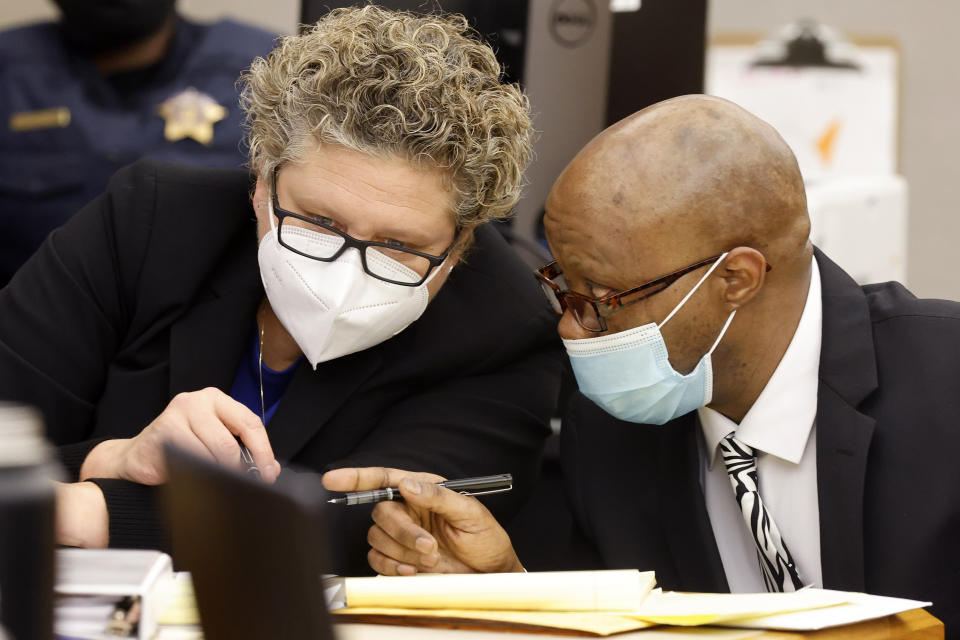 Private investigator Tonia Silva talks with defendant Billy Chemirmir during a video deposition by victim Mary Bartel during the murder trial of Chemirmir at the Frank Crowley Courts Building in Dallas, Monday, Nov. 15, 2021. Chemirmir is charged with killing 18 older women in Dallas and its suburbs over a two-year span. (Tom Fox/The Dallas Morning News via AP, Pool)