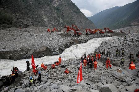 Rescue workers search for survivors at the site of a landslide in the village of Xinmo, Mao County, Sichuan Province, China June 26, 2017. Picture taken June 26, 2017. REUTERS/Aly Song