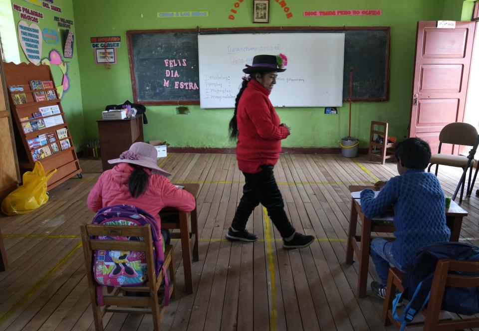 Alicia Cisneros teaches the Quechua Indigenous language to primary school students at a public school in Licapa, Peru, Wednesday, Sept. 1, 2021. Peru´s new Education Minister Juan Cadillo says the government aims to increase the number of bilingual teachers like Cisneros in public schools. (AP Photo/Martin Mejia)