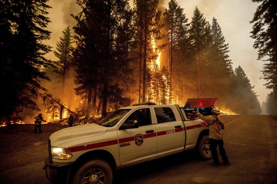 Firefighters monitor a backfire they lit to stop the Dixie Fire from spreading near Prattville in Plumas County, Calif., on Friday, July 23, 2021. (AP Photo/Noah Berger)