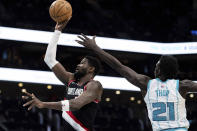 Portland Trail Blazers center Deandre Ayton (2) shoots the ball while guarded by Charlotte Hornets forward JT Thor (21) during the second half of an NBA basketball game Wednesday, April 3, 2024, in Charlotte, N.C. (AP Photo/Jacob Kupferman)