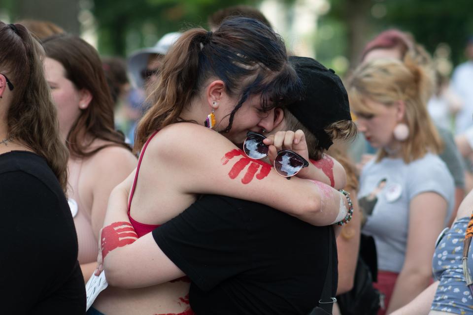 19-year-old Topekan Chole Easley, left, hugs her friends after sharing her story of sexual abuse to others gathered on the Statehouse steps Friday during an abortion-rights rally.