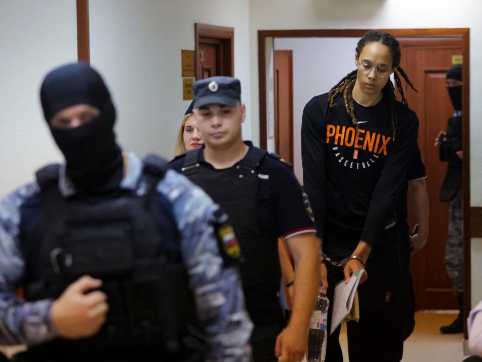 WNBA star and two-time Olympic gold medalist Brittney Griner is escorted to a courtroom for a hearing, in Khimki just outside Moscow, Russia, Wednesday, July 27, 2022.