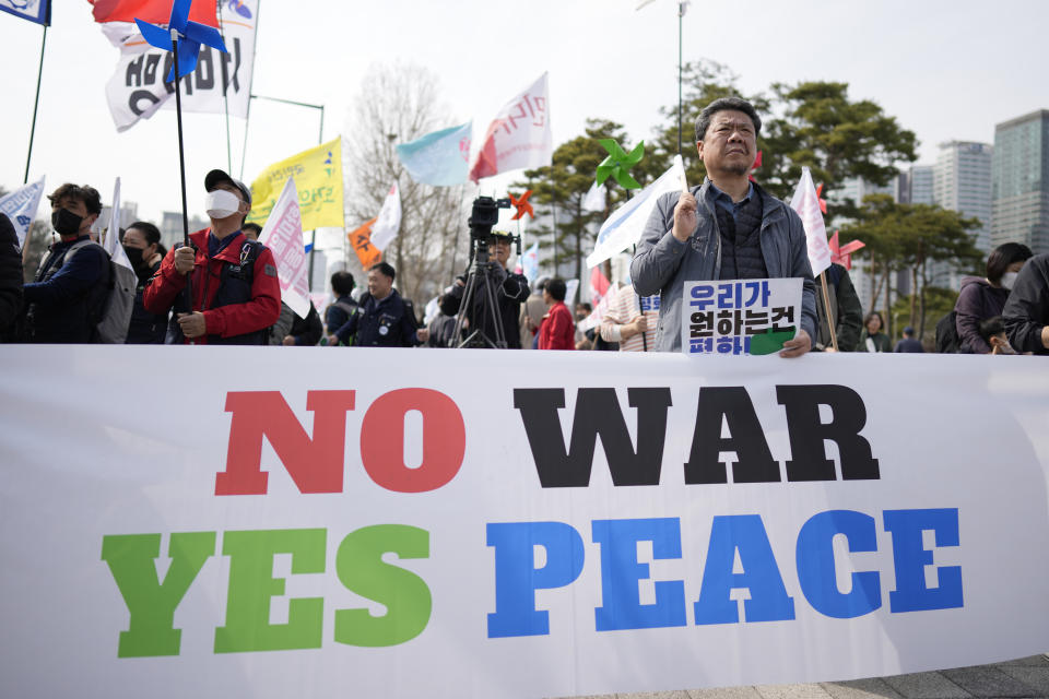 Protesters hold signs during a rally to oppose to the planned the joint military exercises between the U.S. and South Korea, in Seoul, South Korea, Saturday, March 11, 2023. South Korea's military said Monday, March 27, 2023, it detected North Korea firing at least one ballistic missile toward the sea off its eastern coast, adding to a recent flurry in weapons tests as the United States steps up its military exercises with the South to counter the North's growing threat. (AP Photo/Lee Jin-man)