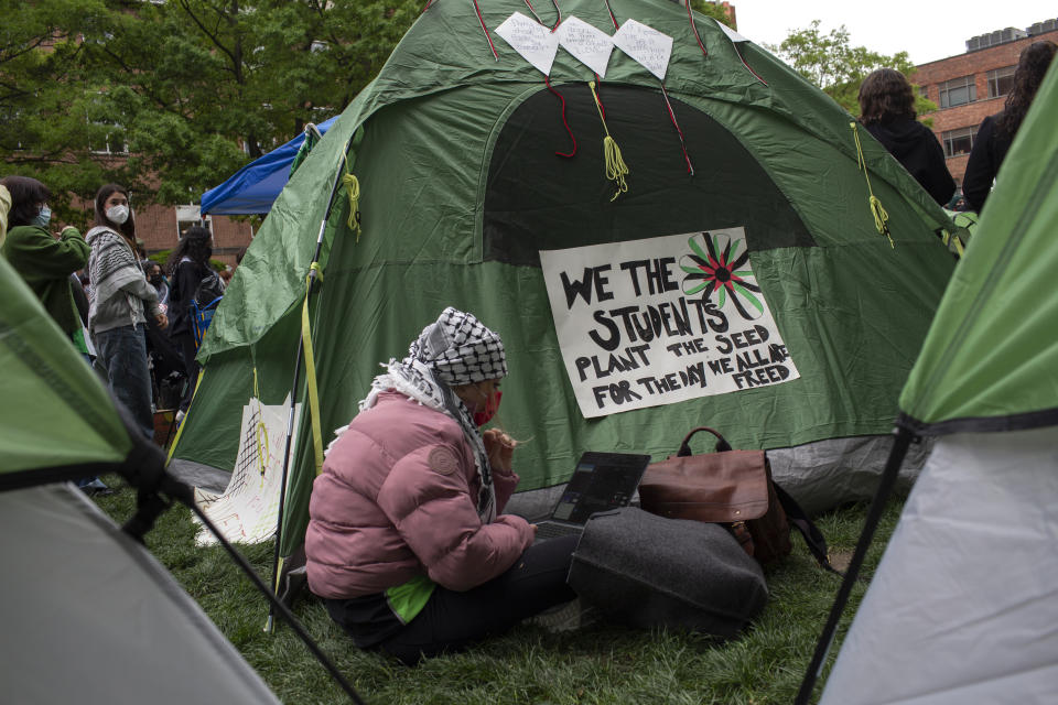 A student uses a laptop while sitting in an encampment set up in support of Gaza at George Washington University. (Probal Rashid/LightRocket via Getty Images)