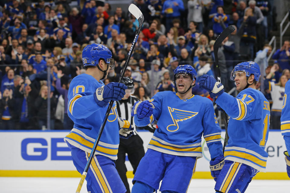 St. Louis Blues' Jaden Schwartz, right, celebrates with David Perron, middle and Brayden Schenn after scoring a goal against the Nashville Predators during the second period of an NHL hockey game Saturday, Feb. 15, 2020, in St. Louis. (AP Photo/Billy Hurst)