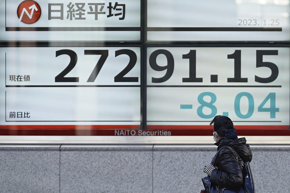 A person watches an electronic stock board showing Japan's Nikkei 225 index at a securities firm Wednesday, Jan. 25, 2023, in Tokyo. Asian shares were mixed Wednesday after Wall Street indexes finished little changed as investors awaited earnings results from major global companies. (AP Photo/Eugene Hoshiko)