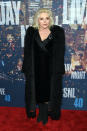 Blondie brings it like only an icon can in a long black fur coat, velvet dress, and booties.