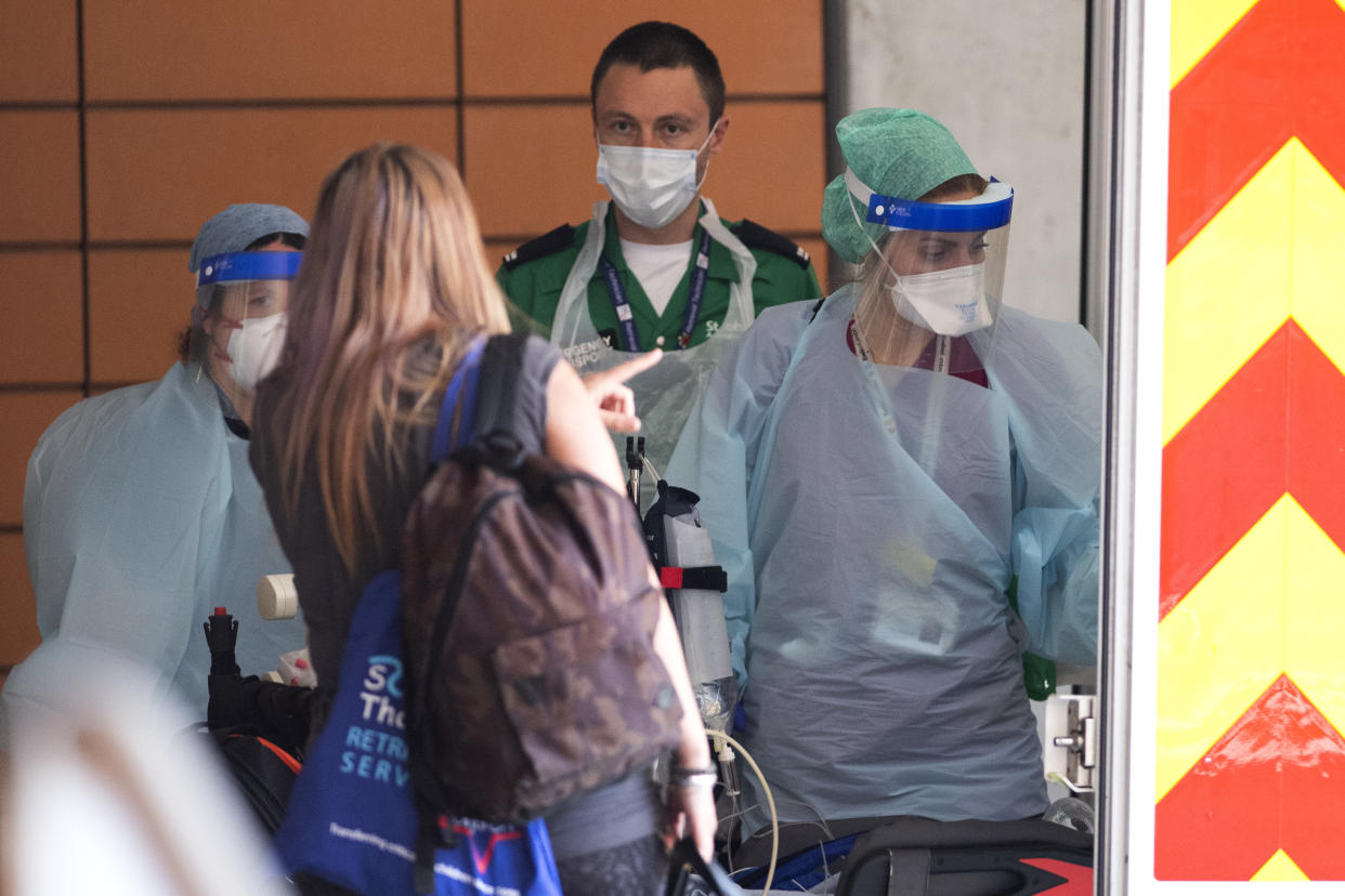 LONDON, UNITED KINGDOM - APRIL 10: NHS workers in PPE attend to a patient at St Thomas' Hospital on April 10, 2020 in London, England. Public Easter events have been cancelled across the country, with the government urging the public to respect lockdown measures by celebrating the holiday in their homes. Over 1.5 million people across the world have been infected with the COVID-19 coronavirus, with over 7,000 fatalities recorded in the United Kingdom.   (Photo by Justin Setterfield/Getty Images)