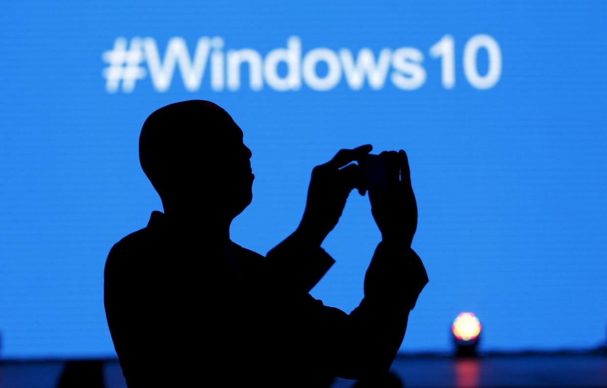 A Microsoft delegate takes a picture during the launch of the Windows 10 operating system in Kenya's capital Nairobi, July 29, 2015: REUTERS/Thomas Mukoya