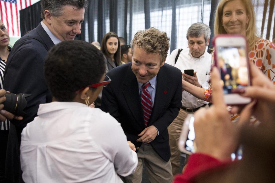 Sen. Rand Paul, R-Ky., greets Angelika Noel, 17, during a visit to Josephinum Academy in Chicago to participate in a discussion on school choice on Tuesday, April 22, 2014. (AP Photo/Andrew A. Nelles)