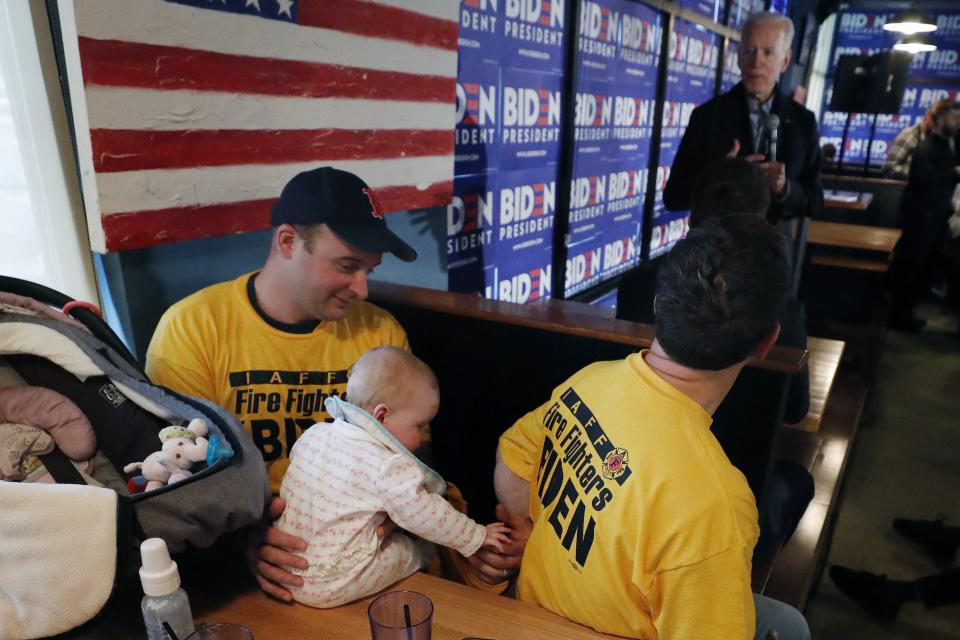 Firefighters listen as former vice president and Democratic presidential candidate Joe Biden speaks during a campaign stop at the Community Oven restaurant in Hampton, N.H., Monday, May 13, 2019. (AP Photo/Michael Dwyer)