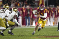 Southern California quarterback Caleb Williams, right, runs the ball as Notre Dame safety Xavier Watts, left, and defensive lineman Justin Ademilola defend during the second half of an NCAA college football game Saturday, Nov. 26, 2022, in Los Angeles. (AP Photo/Mark J. Terrill)