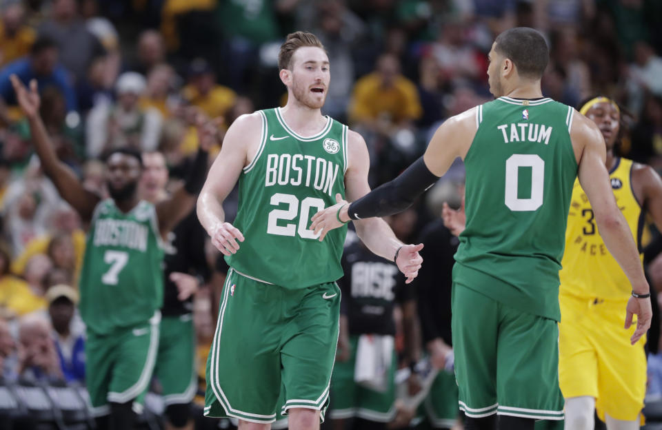 Boston Celtics forward Gordon Hayward (20) and forward Jayson Tatum (0) celebrate during the second half of Game 4 against the Indiana Pacers in the NBA basketball first-round playoff series in Indianapolis, Sunday, April 21, 2019. The Celtics defeated the Pacers 110-106 to win the series 4-0. (AP Photo/Michael Conroy)