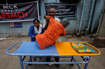 A patient leaves after not getting treatment from at a government hospital during a strike by doctors demanding security after the recent assaults on doctors by the patients' relatives, in Kolkata