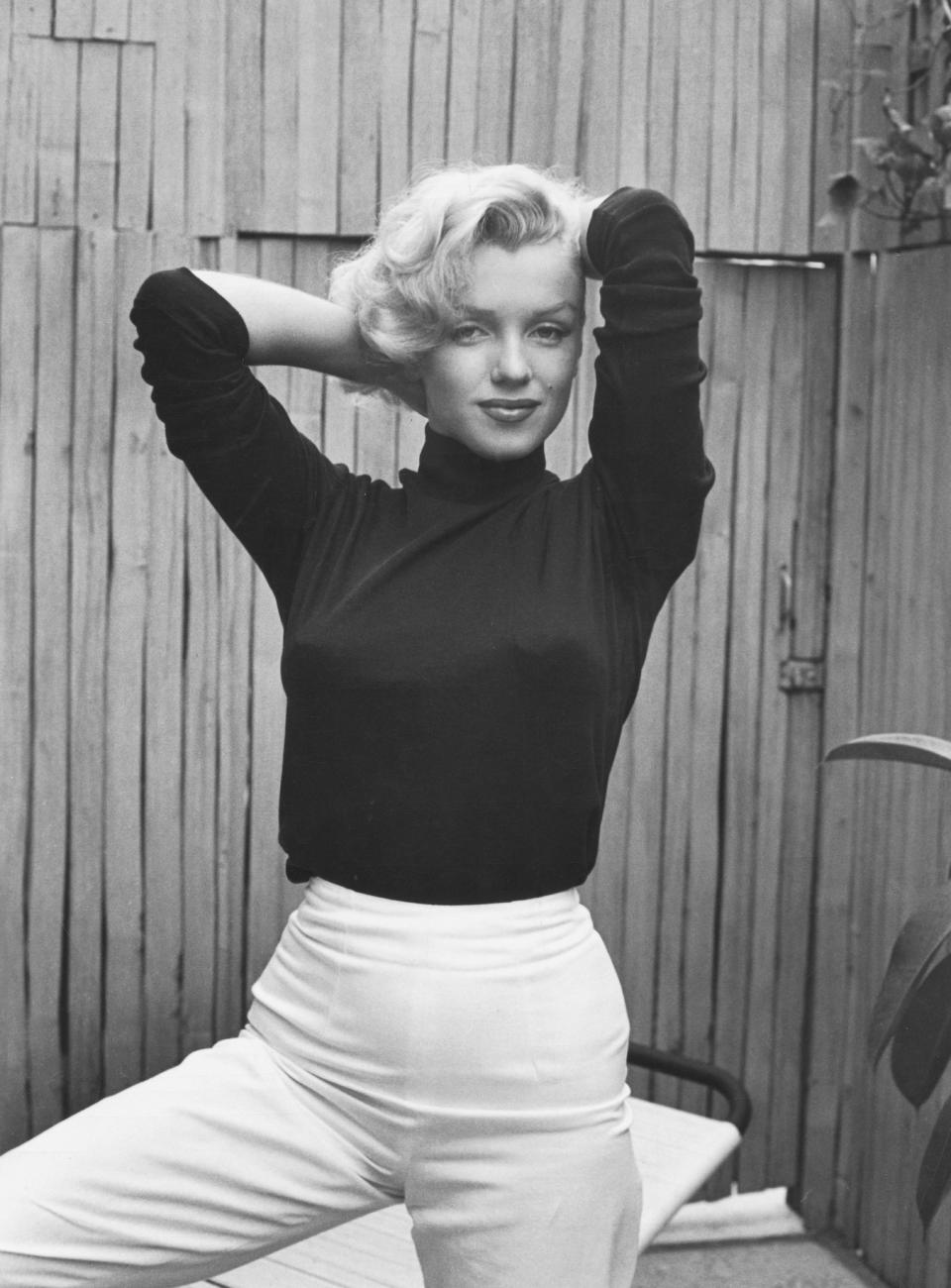 The actress poses in a black turtleneck at her home in 1953.