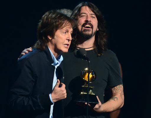 Winners for Best Rock Song Paul McCartney (L) and Dave Grohl (with Krist Novoselic and Pat Smear) give their acceptance speech on stage during the 56th Grammy Awards at the Staples Center in Los Angeles, California, January 26, 2014