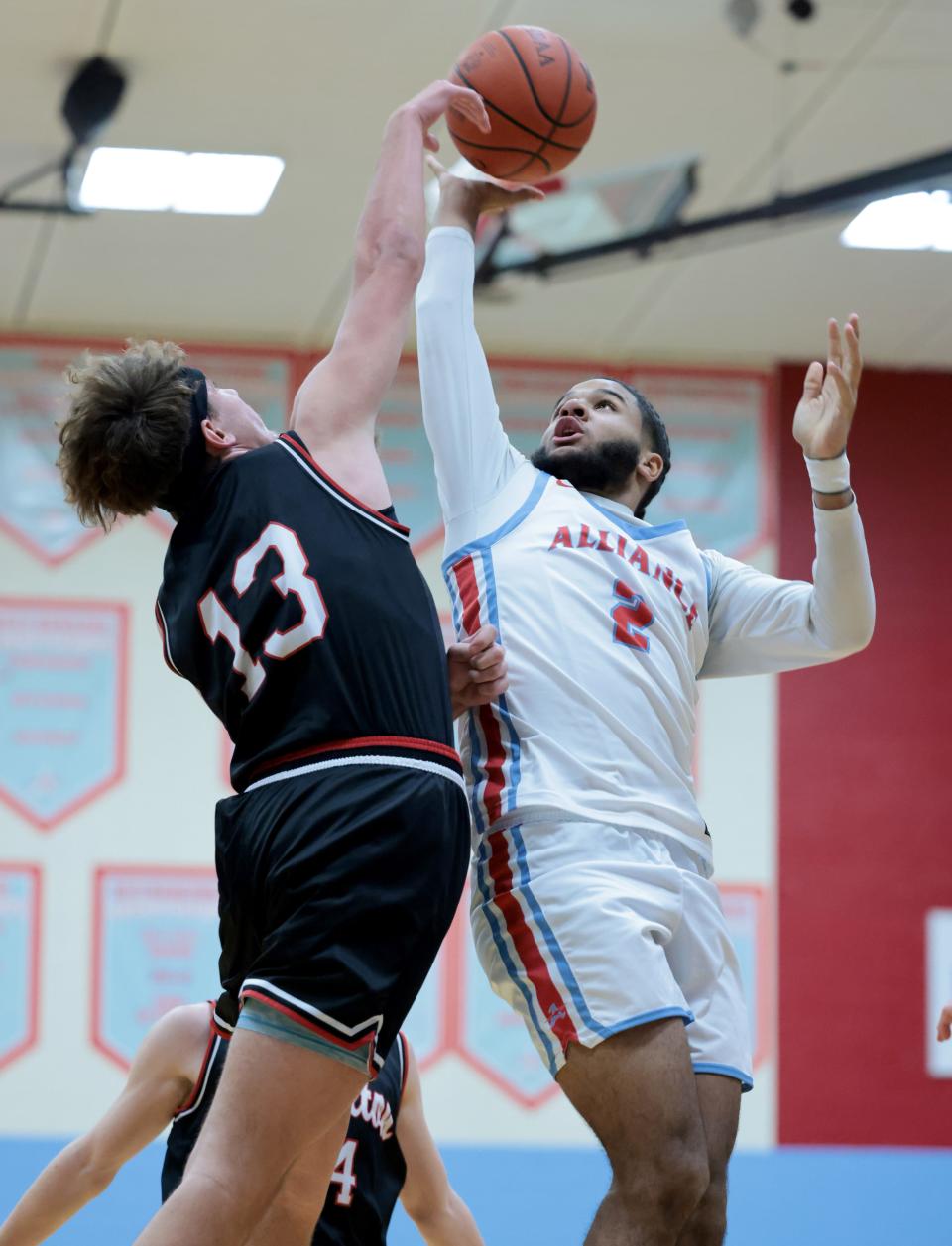 Alliance's K'Vaughn Davis puts up a shot over the defense of Carrollton's Cadyn Smith in the first half at Alliance, Friday, Jan. 20, 2023.