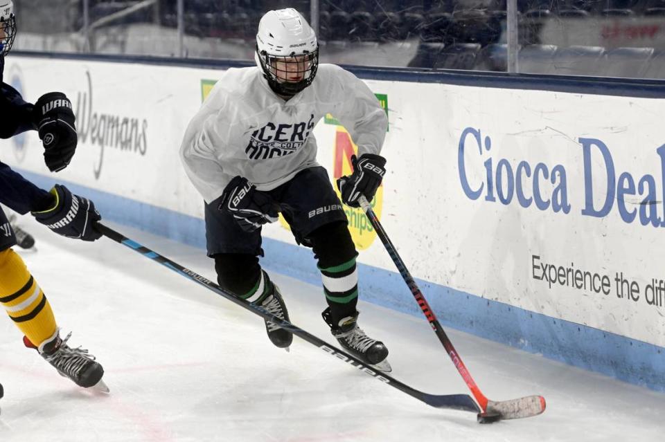 Quinn Hixson, 14, skates down he ice with eh puck ahead of a teammate during State College middle school secondary hockey team practice on Friday, March 17, 2023 at Pegula Ice Arena.