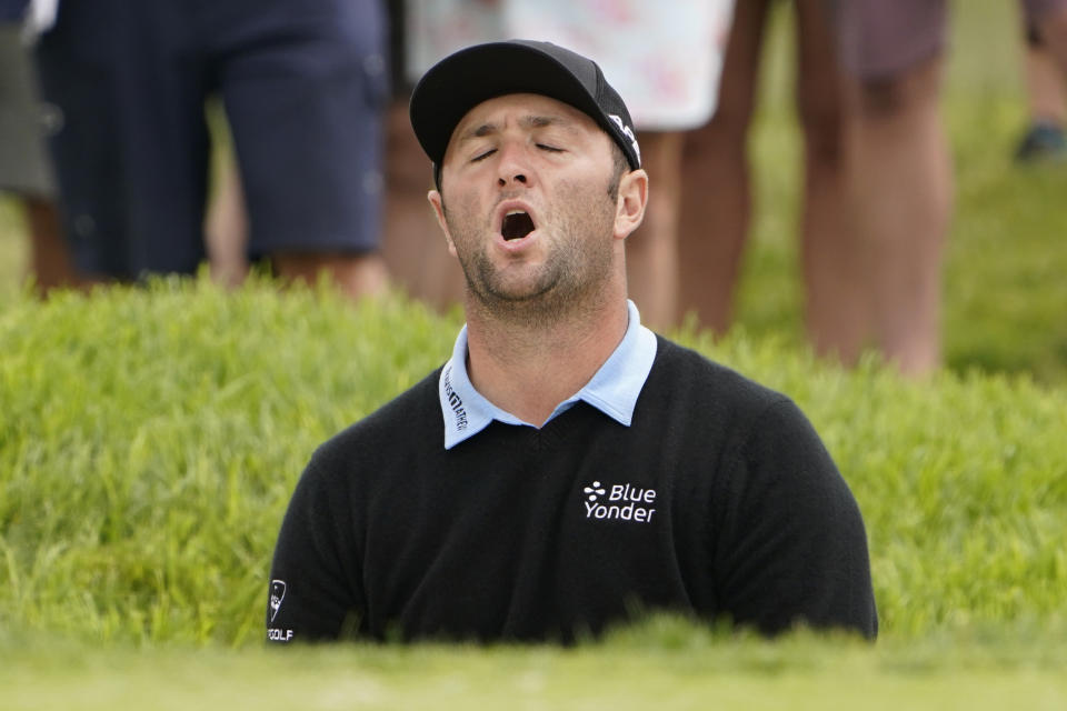 Jon Rahm, of Spain, reacts after missing his shot from a bunker on the 11th hole during the second round of the U.S. Open Golf Championship, Friday, June 18, 2021, at Torrey Pines Golf Course in San Diego. (AP Photo/Jae C. Hong)