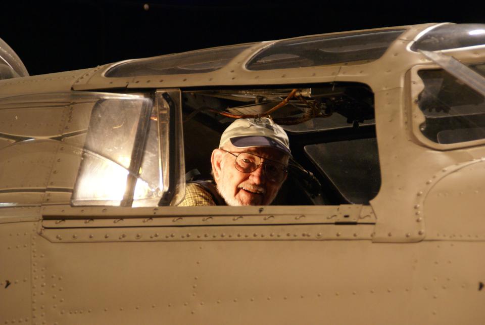 John Billings sits in the cockpit of a B-24 plane, which is what he flew during World War II.