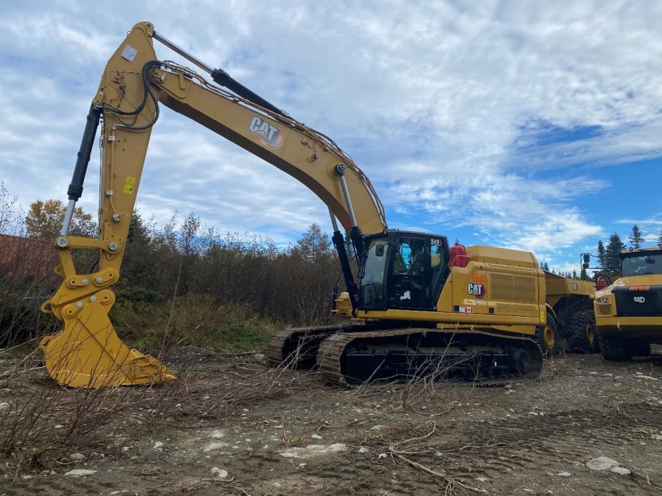 Caterpillar 349 excavator (top) and two Caterpillar 745 45t articulated haul trucks (bottom)