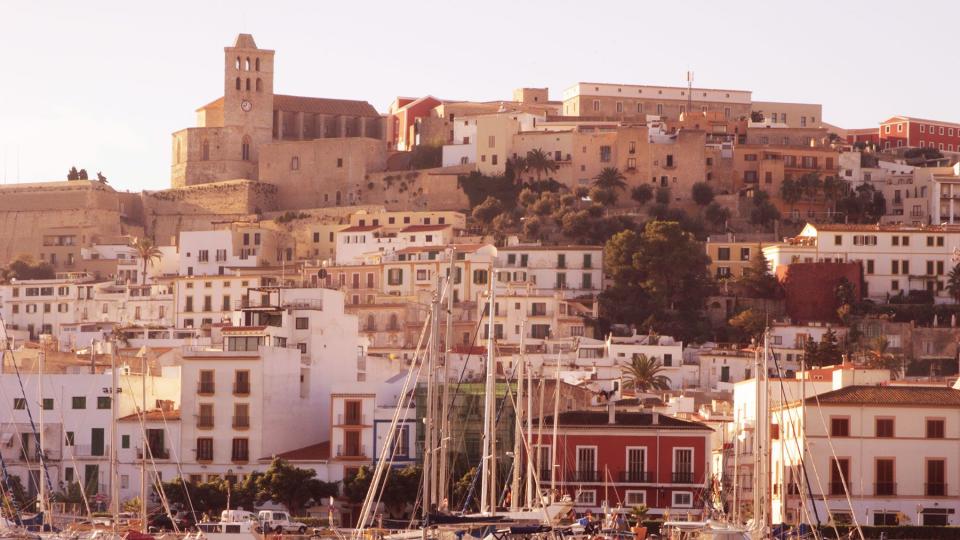 Golden early morning light falls on old town Ibiza