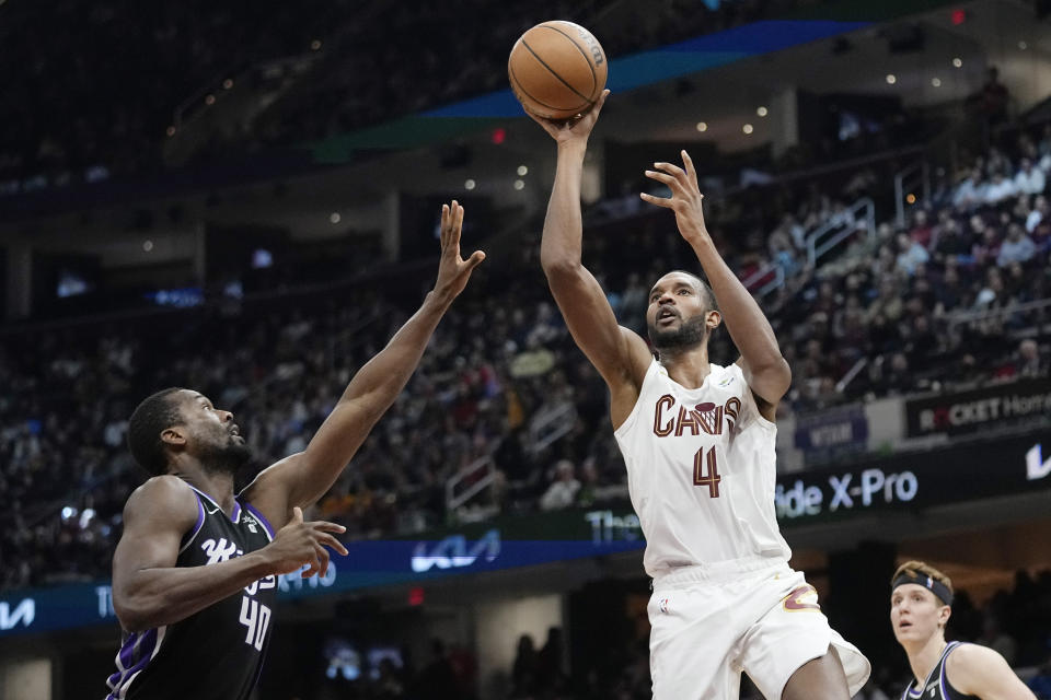 Cleveland Cavaliers forward Evan Mobley (4) shoots in front of Sacramento Kings forward Harrison Barnes (40) in the second half of an NBA basketball game, Monday, Feb. 5, 2024, in Cleveland. (AP Photo/Sue Ogrocki)