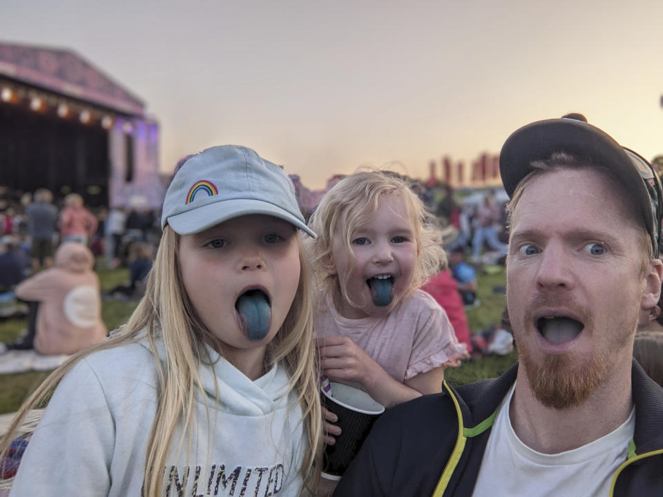 Family portrait at festival with all blur and selected Google Magic Eraser suggestions combined