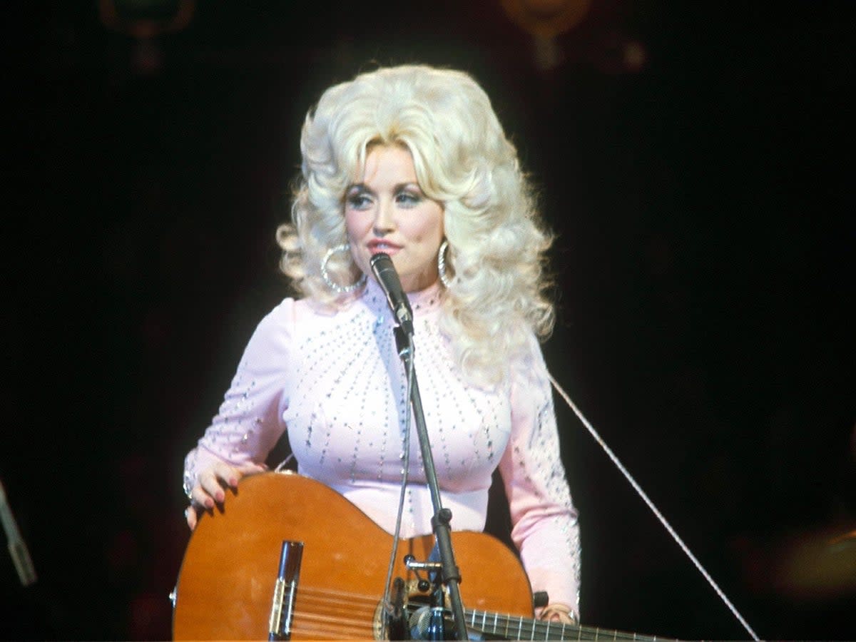 Dolly Parton sparkling on stage in 1976 (Armando Pietrangeli/Shutterstock)