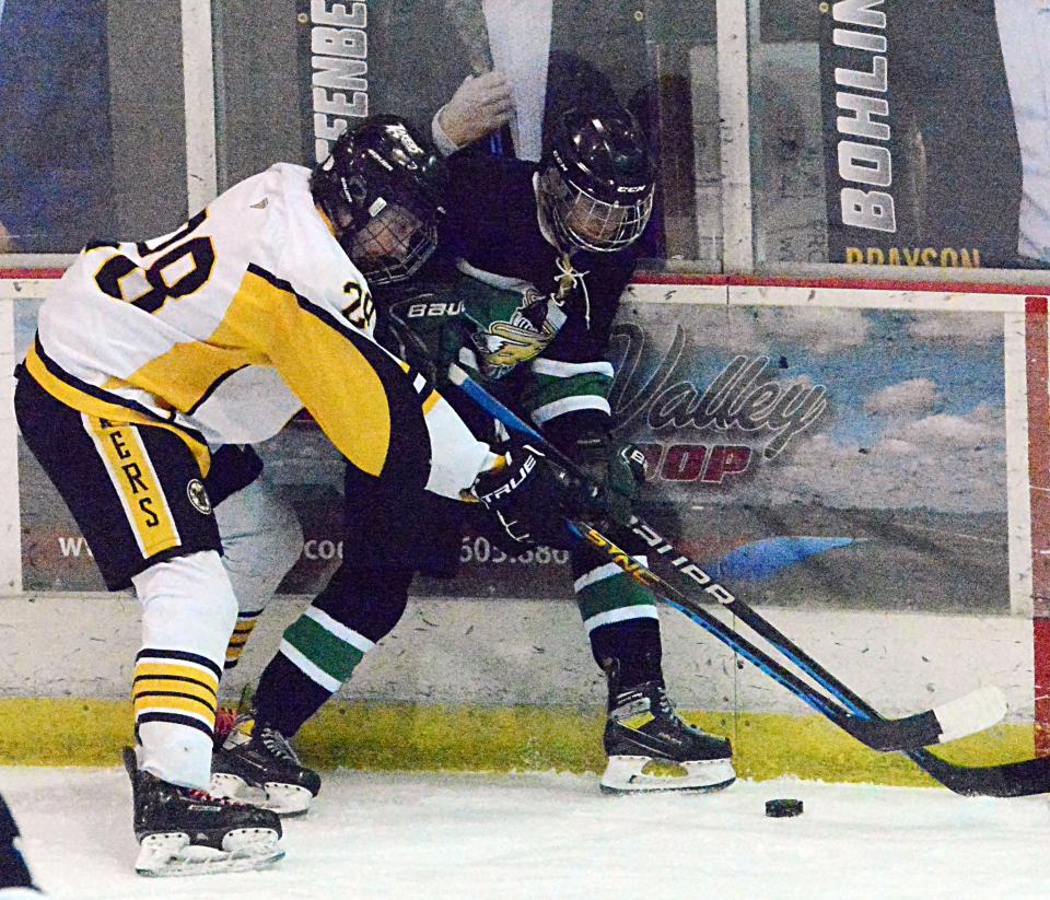 Logan Austad of the Watertown Lakers battles for the puck with Riley Pfeifer of the Oahe Capitals during their South Dakota Amateur Hockey Association varsity boys' game on Saturday, Feb. 25, 2023 in the Maas Ice Arena.