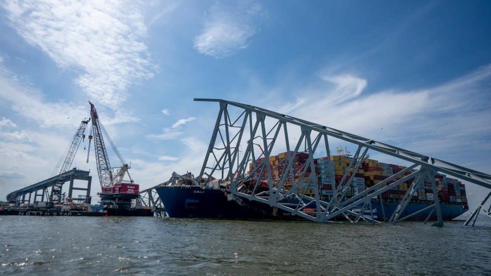 Crews work to remove the wreckage of the Francis Scott Key Bridge atop the cargo vessel Dali in the Patapsco River