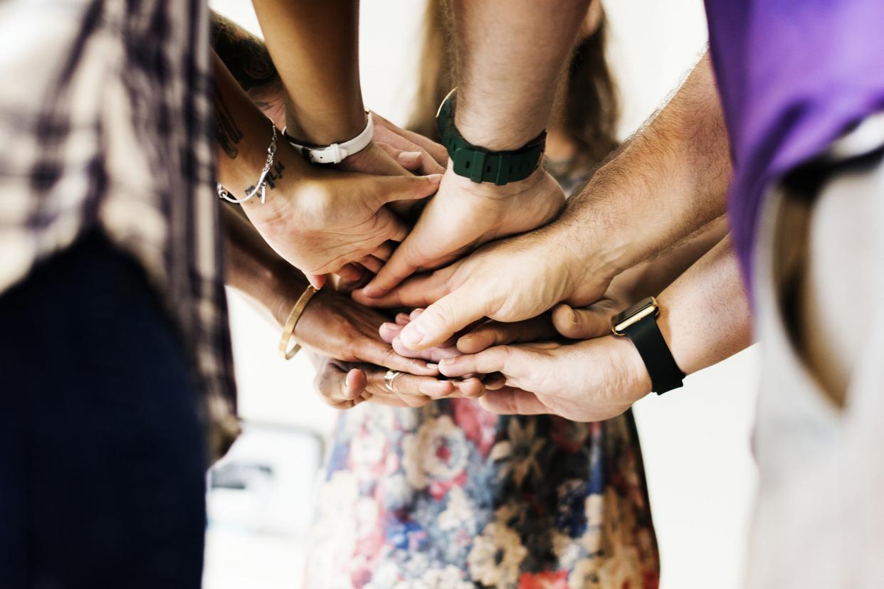 group of diverse people joined hands together teamwork