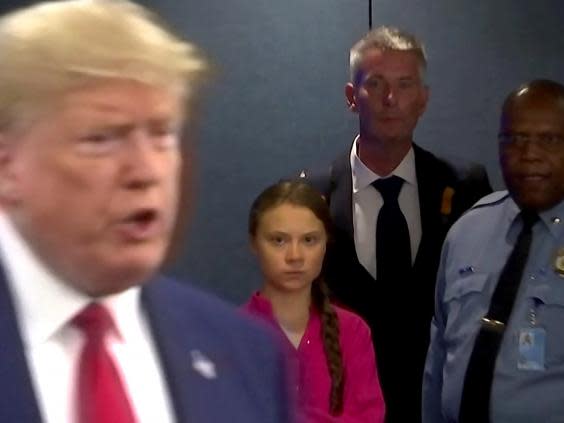 Greta Thunberg watches Donald Trump speak to reporters (REUTERS)