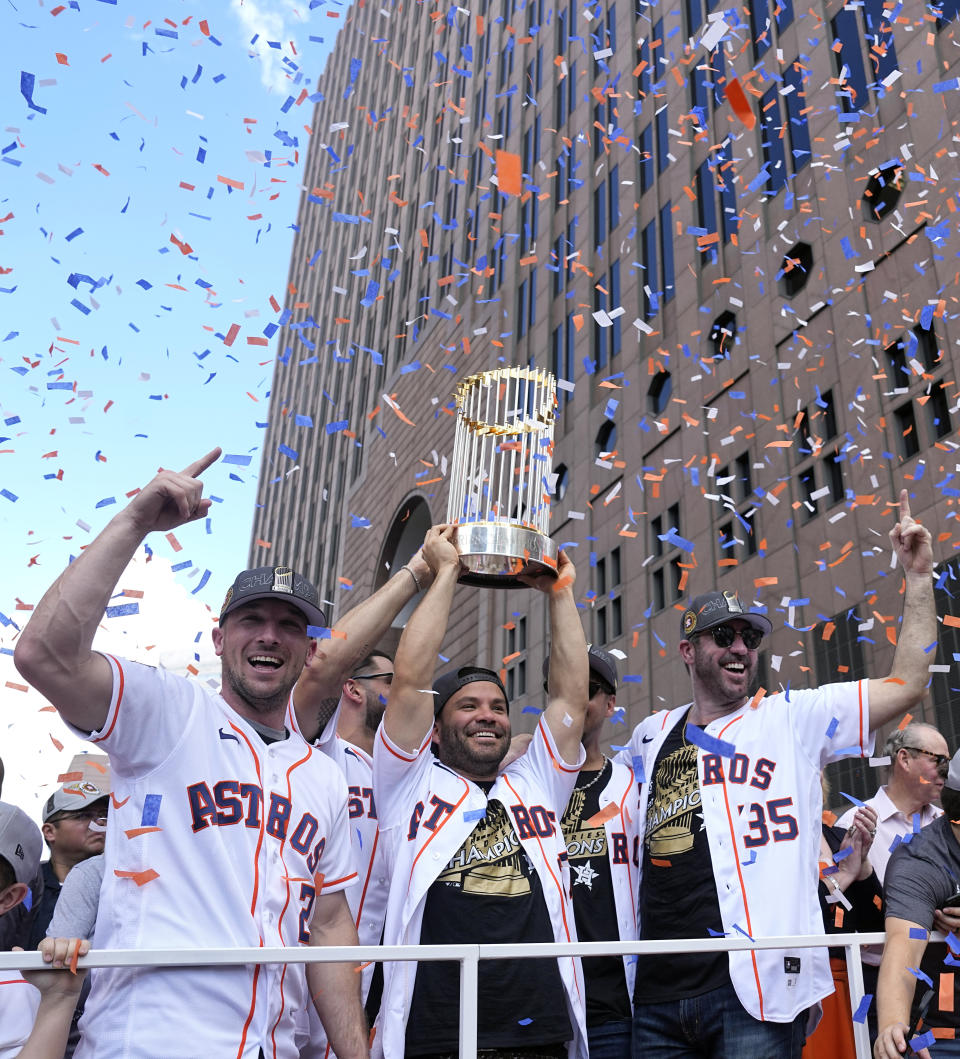 Houston Astros Alex Bregman (2), Jose Altuve, center, and Justin Verlander (35) celebrate during a World Series baseball championship parade Monday, Nov. 7, 2022, in Houston. The Astros beat the Philadelphia Phillies to win their second World Series. (AP Photo/David J. Phillip)