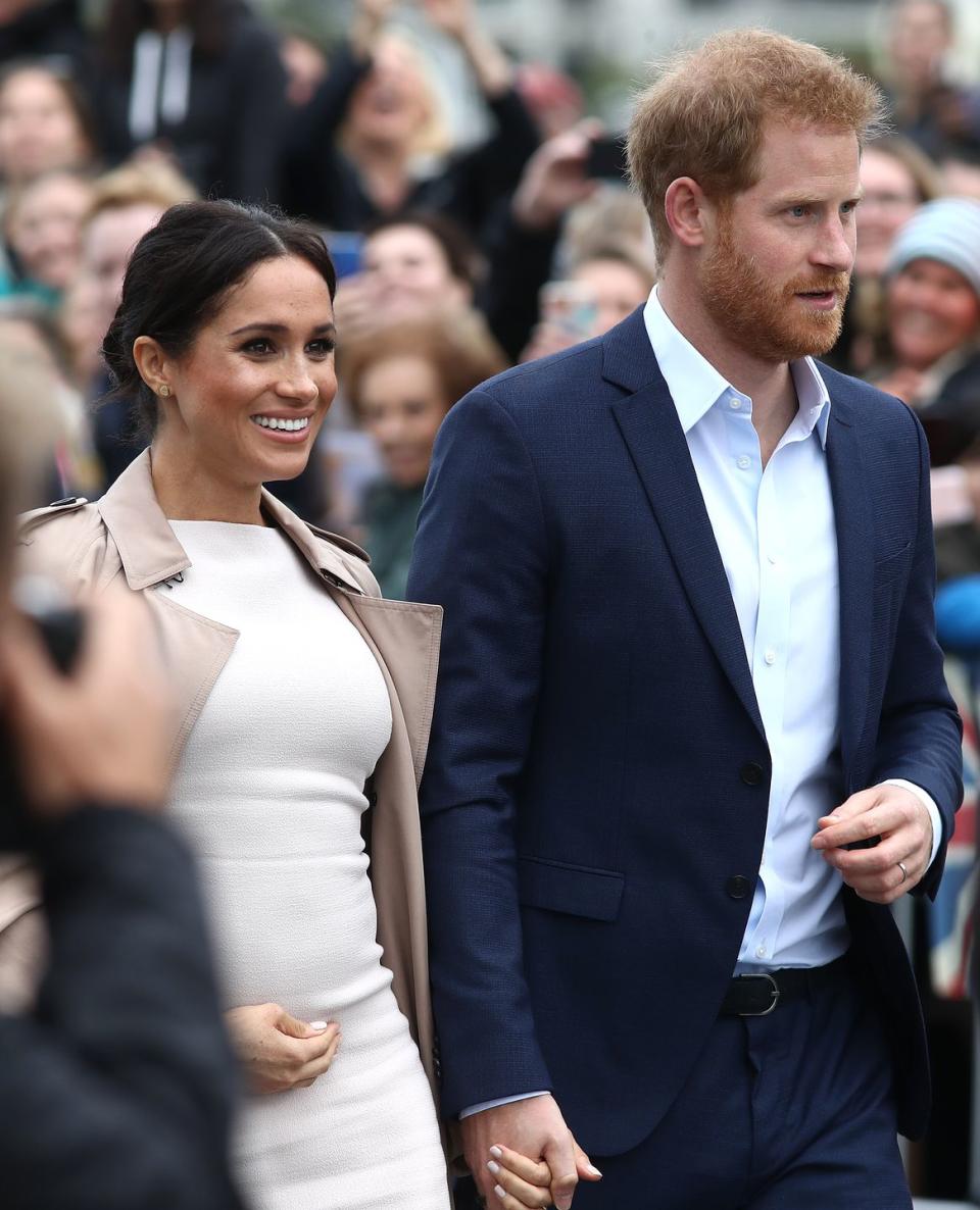 Meghan and Harry hold hands as they greet the public in Auckland.