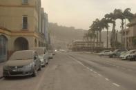 Ash covers roads a day after the La Soufriere volcano erupted after decades of inactivity in St Vincent and the Grenadines