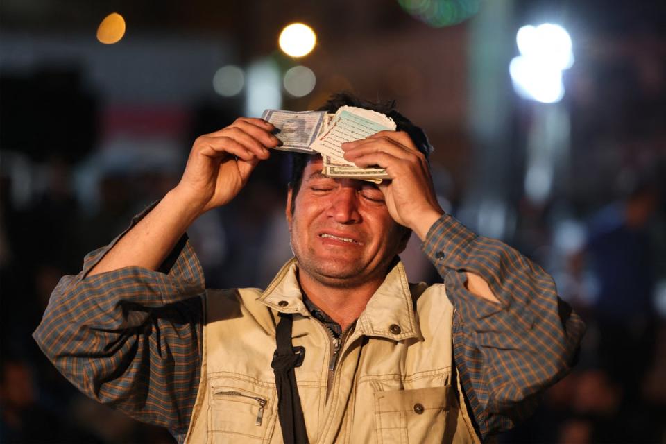 In Tehran, Iranian men and women were pictured publicly praying for their missing president (AFP)