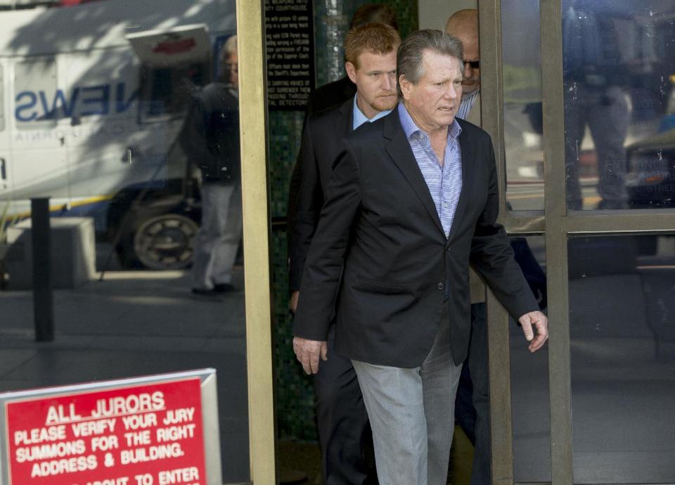 Actor Ryan O'Neal, front, and son, Redmond O'Neal, exit court for a lunch break on Thursday, Dec. 12, 2013, in Los Angles. Attorneys for O’Neal concluded their case in the actor’s bid to keep a version of an Andy Warhol portrait of his longtime partner Farrah Fawcett. The former couple’s son Redmond O’Neal was among the final witnesses. (AP Photo/Damian Dovarganes)