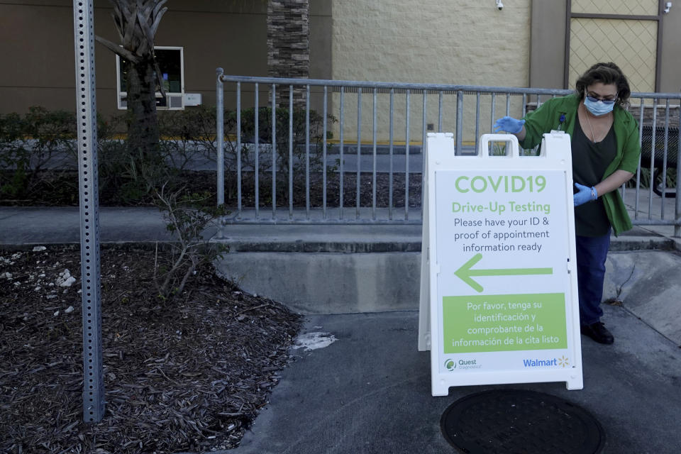 Lisa Wiley, of Walmart, sets up for the opening at a new drive-up self-administered COVID-19 testing site run by Quest Diagnostics at the Walmart store in Boynton Beach, Fla,, Tuesday, June 16, 2020. (Joe Cavaretta/South Florida Sun-Sentinel via AP)