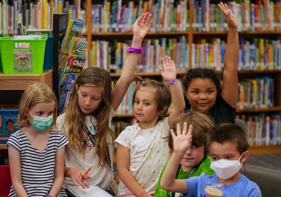 Students raise their hands to answer a question during Resilience Camp on Tuesday, June 28, 2022, at Spring Mill Elementary School in Indianapolis. Emily Dills, Washington Township's social emotional learning coach, created the week-long summer program for students grades K-5 to help fill learning and social gaps created by the pandemic. 