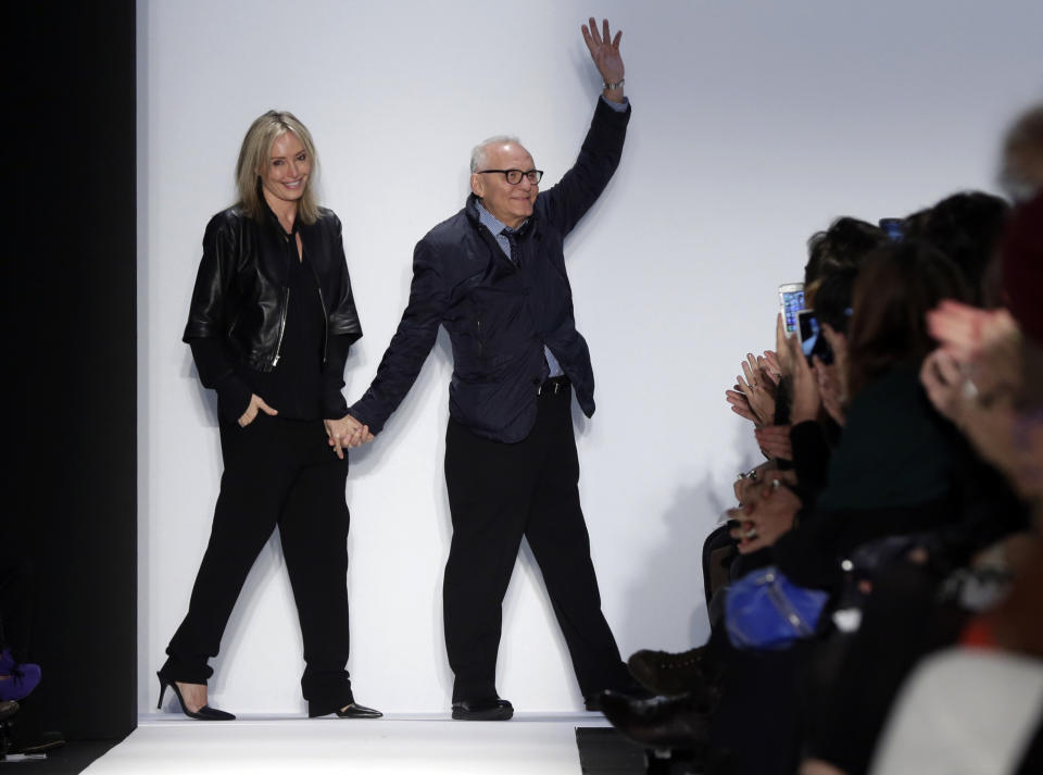 Designer Max Azria and his wive Lubov acknowledge applause after the BCBG Max Azria Fall 2013 collection was modeled, during Fashion Week in New York, Thursday, Feb. 7, 2013. (AP Photo/Richard Drew)