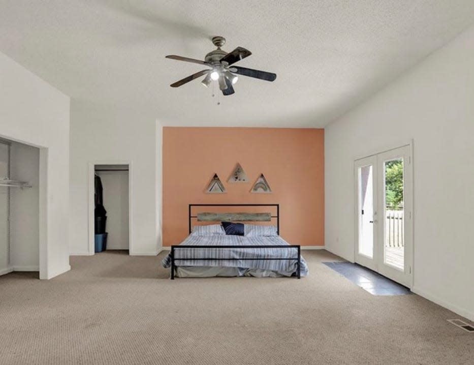 The master bedroom is on the upper level of the home. That upper level looks over the gym.