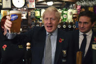 Britain' Prime Minister Boris Johnson raises a pint of beer, as he meets with military veterans at the Lych Gate Tavern in Wolverhampton, England, Monday, Nov. 11, 2019 as part of the General Election campaign trail. Britain goes to the polls on Dec. 12. (Ben Stansall/Pool Photo via AP)