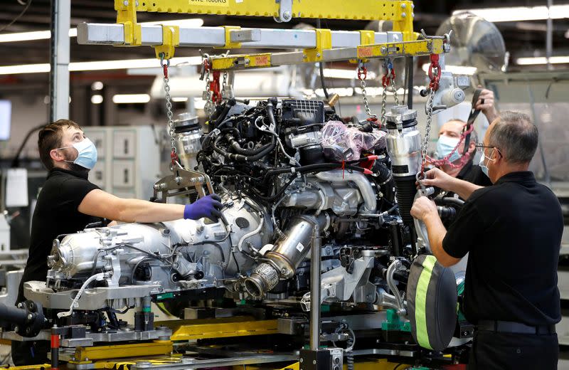 FILE PHOTO: Technicians work on a Rolls-Royce engine prior to it being installed in a car on the production line of the Rolls-Royce Goodwood factory, near Chichester